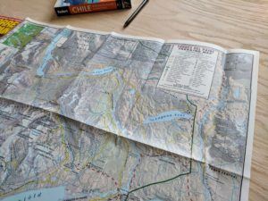 徒步旅行者阅读路线地图。学习如何阅读地形图的关键功能和技巧，以帮助您导航和理解步道上的等高线。