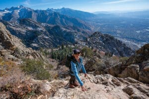 Women standing on rocky section of the Mount Olympus Trail overlooking Salt Lake City Utah