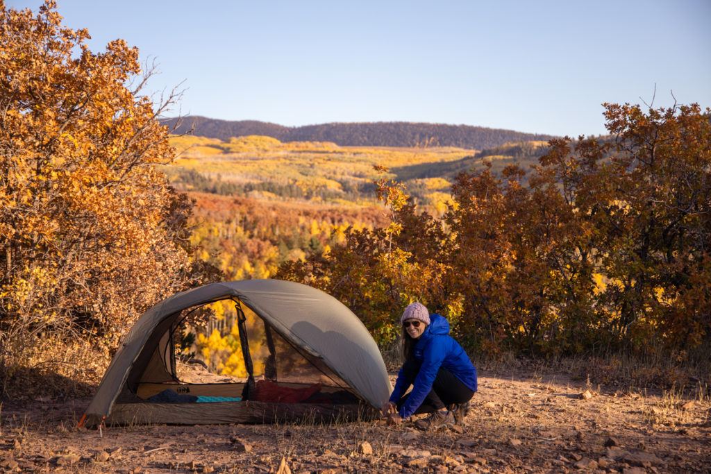 Kristen tent camping in Colorado during the fall // The Dyrt Pro is the #1 camping app with over 45,000 reviewed campgrounds to help you plan and book your next trip. See our full review here.