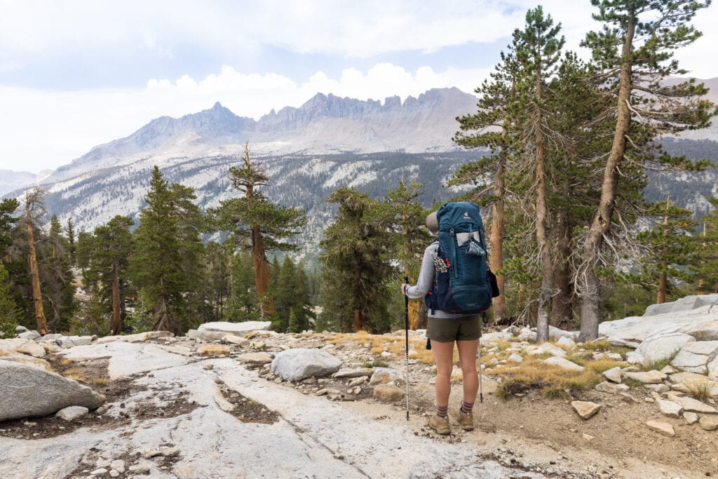 Female backpacker wearing The North Face Aphrodite Shorts while backpacking in the Sierra mountains of California.