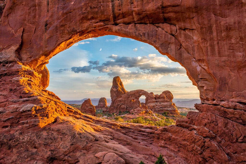 Landscape photo looking through North Window arch in Arches National Park in Utah