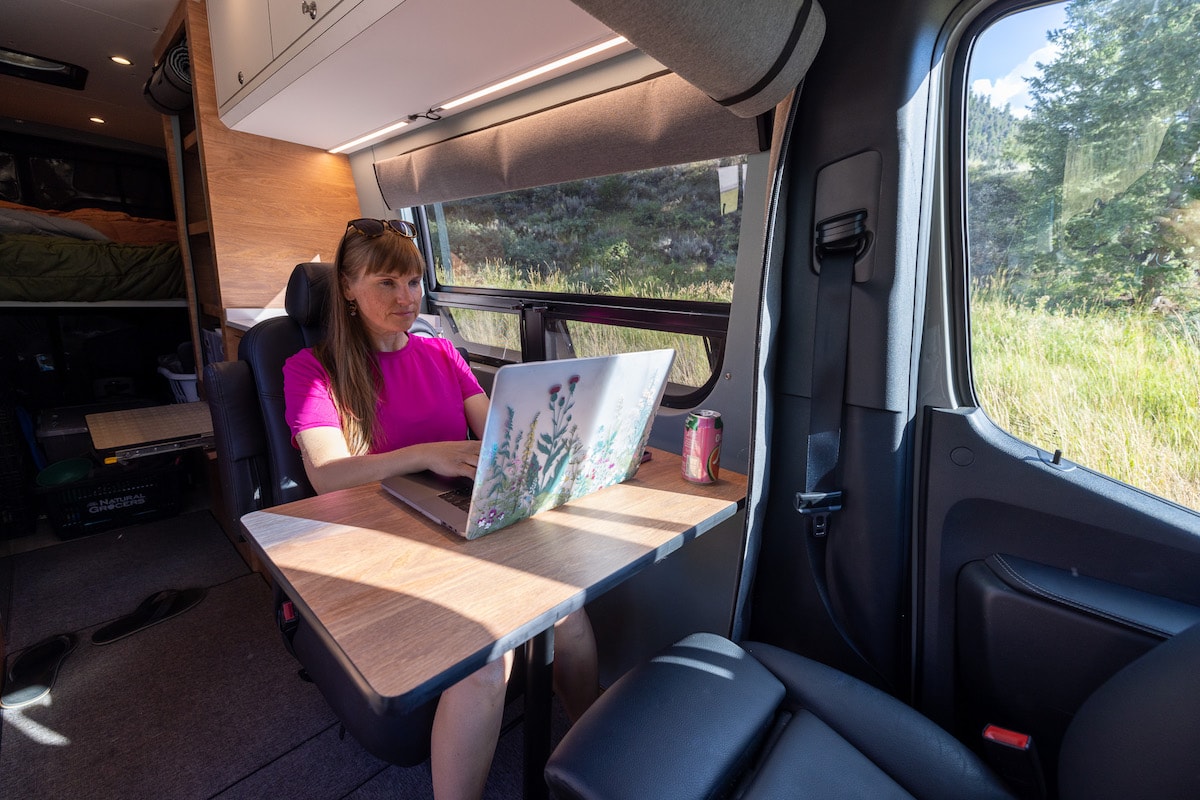 4x4 Sprinter Van Conversion built by Outside Van with a third passenger seat that doubles as a desk and dining area