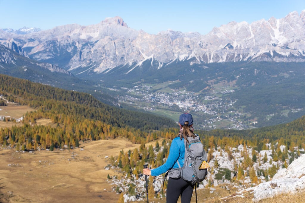 A woman stands on the hiking trail in Italy wearing the Gregory Jade 28 day pack