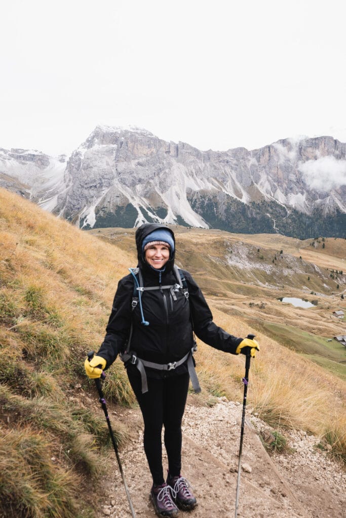A woman hikes in Italy wearing Outdoor Research Aspire II Rain Jacket