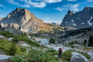 Three backpackers on the trail of Cirque of the Towers, Wind River Range, Wyoming