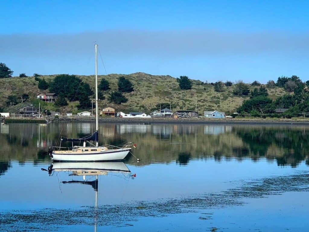 Sailboat anchored in Bodega Bay Harbor in California