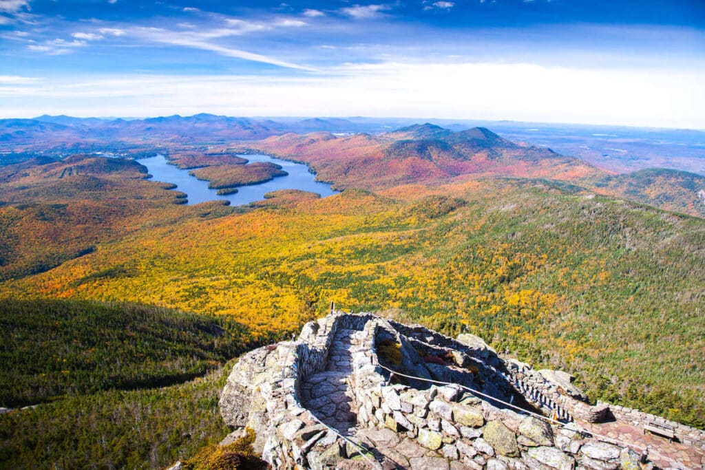 View from top of Whiteface Mountain in New York out over Lake Placid and changing fall foliage landscape