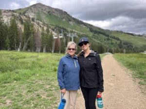 哟ung woman and her mom hiking at Alta Ski Area in summer
